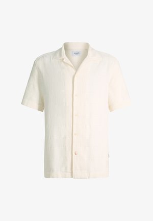 Chemise à manches courtes texturée blanc cassé avec boutons, col camp et motif géométrique subtil.