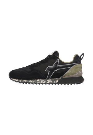 Black and olive green sneaker with camo-patterned sole and a silver lightning bolt design on the side, viewed from the left profile.