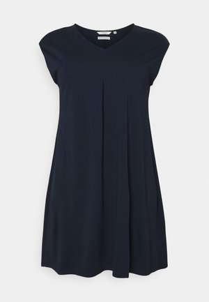 Robe bleu marine avec un col en V, des manches courtes style capuche et des plis. Confectionnée dans un tissu doux et lisse, elle présente une coupe ample en ligne A qui arrive au-dessus du genou.