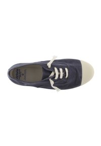 Zapatillas de lona navy con punta de goma blanca, superficie texturizada y cordones de color crema. El interior presenta la etiqueta de la marca.