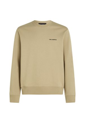 Bežinė džemperis su apvalia iškirpte, raukšlėtomis rankovėmis ir apačia. Ant krūtinės yra mažas juodas logotipas. Pagaminta iš minkštos, tekstūruotos medžiagos.