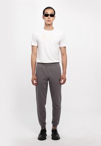 EA7 Emporio Armani TRAIN CORE PANTS - Spodnji deli trenirk - volcanic glass