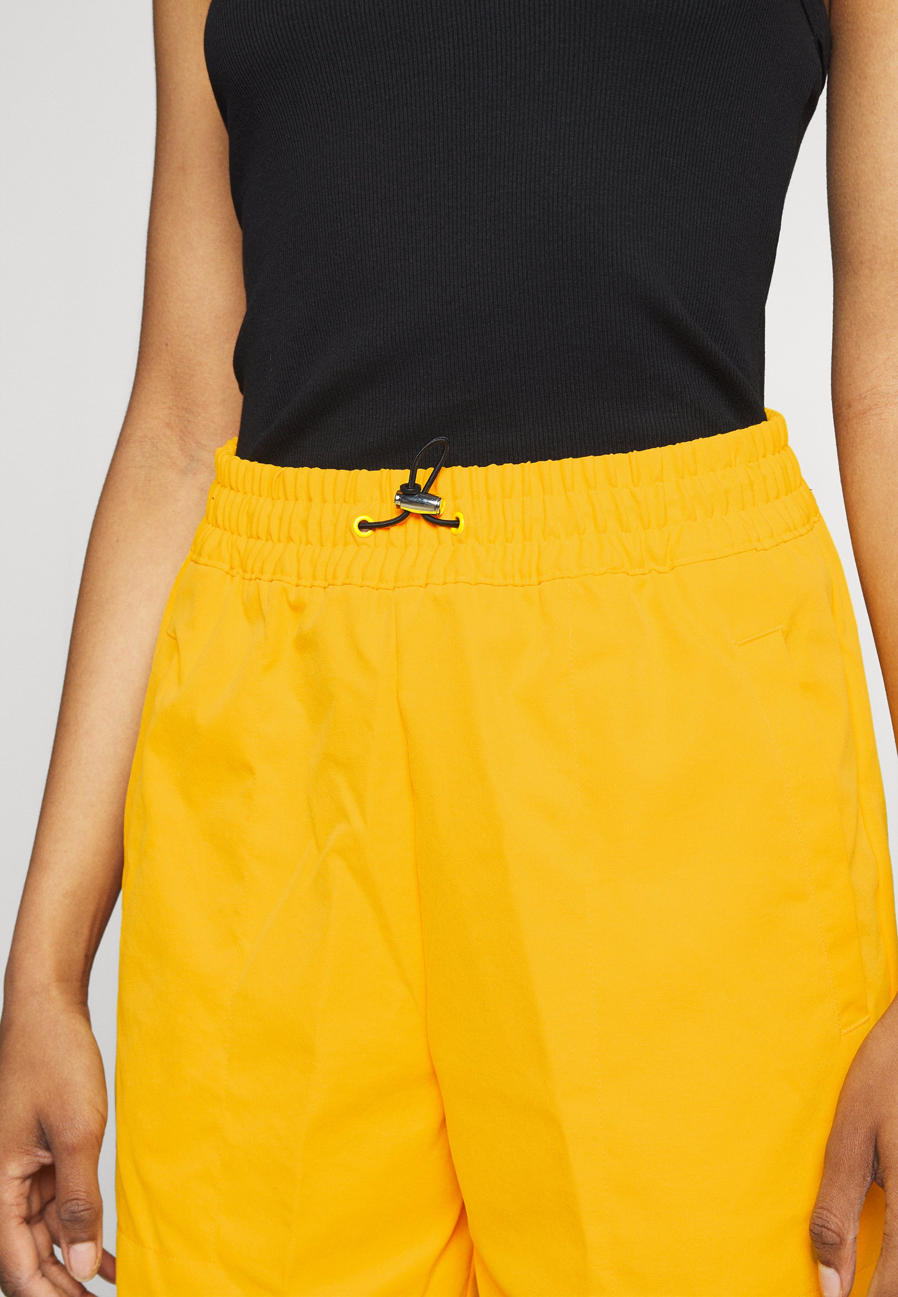 university gold nike shorts