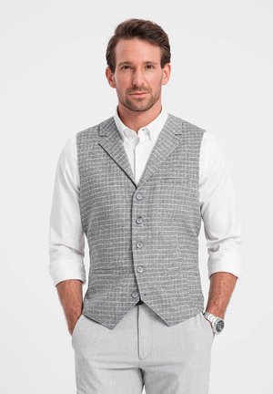 Gray checkered vest with five buttons, worn over a white shirt. The design features a tailored fit with a pocket on the left side.