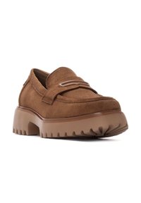 Mocasines de ante marrón con suela de goma gruesa y estriada y un acento decorativo a rayas en la parte superior. Diseño robusto con punta redondeada.