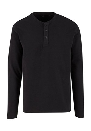 Črna dolgosleeve henley majica iz teksturirane bombažne tkanine, z okroglim ovratnikom in trojnim gumbom na sprednji strani.
