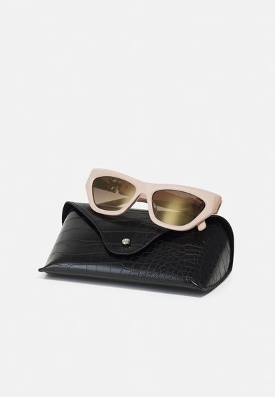 Cat-eye sunglasses in soft pink with gradient lenses resting on a black croc-patterned case with a snap closure.