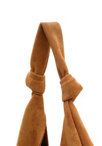 Brown suede shoulder strap with a knotted design. The fabric has a soft, textured surface, creating a smooth appearance.