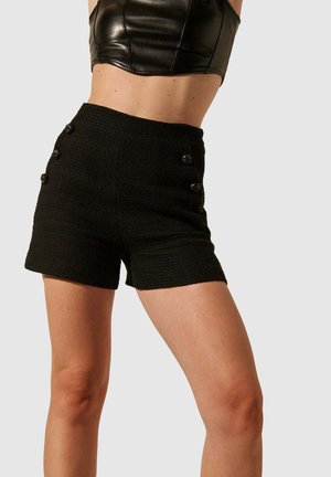 Shorts noirs texturés avec une taille haute et cinq boutons décoratifs noirs à l'avant. Conçus pour une silhouette ajustée.