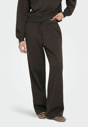 Mørkebrune sweatpants lavet af blødt stof, med elastisk talje og snoretræk. Bred ben design med ribbede ribkant detaljer.