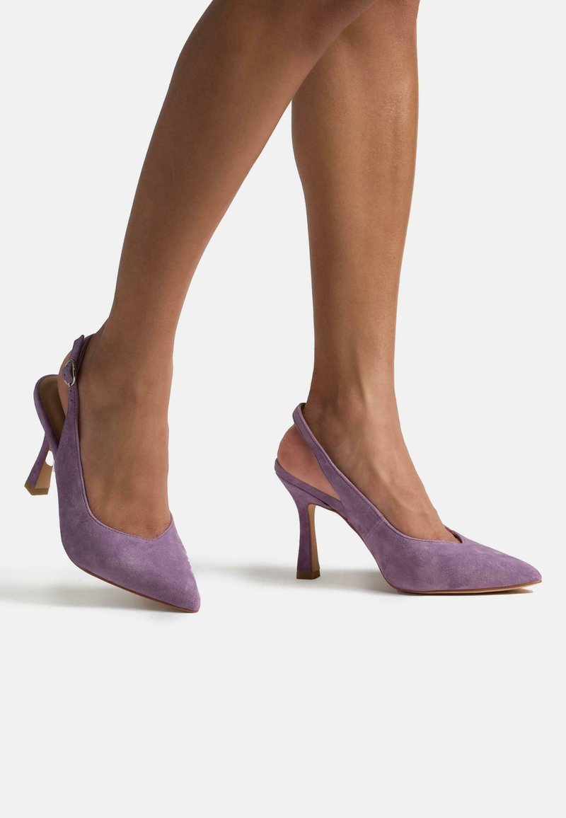 Paarse suède slingback hakken met een spitse neus en een middelhoge stilettohak, voorzien van een slingstrap en een gladde textuur.