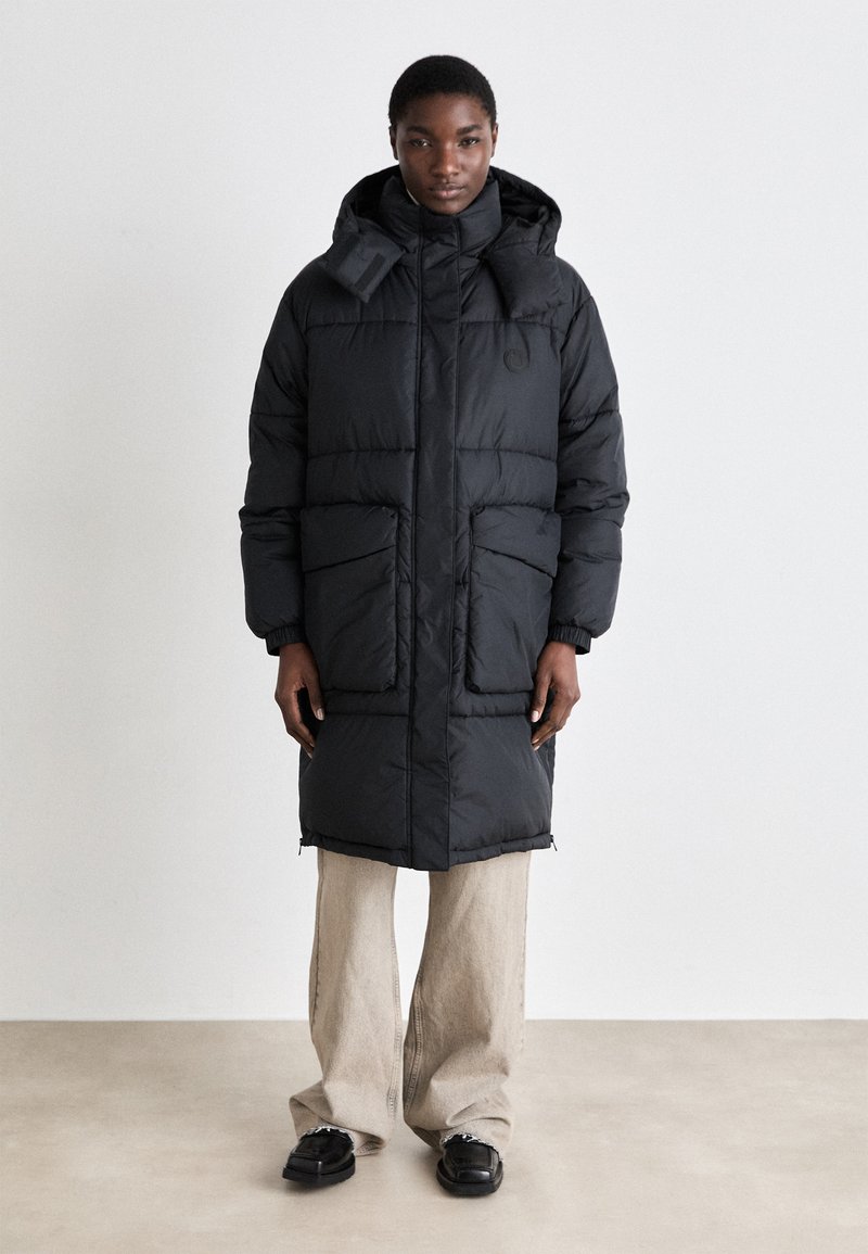 Black puffer coat with a hood, featuring a zip closure, large side pockets, elastic cuffs, and a smooth, shiny texture.