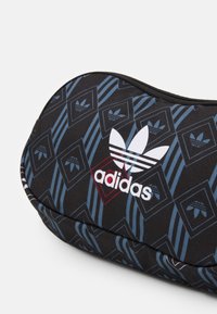 Black canvas pencil case featuring a blue geometric pattern and white Adidas logo with three stripes, zip closure, and rounded shape.