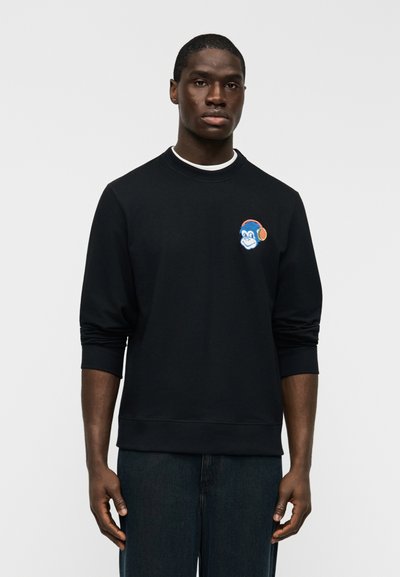 Sweat-shirt noir en coton avec un col rond et des poignets côtelés. Présente un motif brodé d'un singe bleu portant un casque audio sur la poitrine.