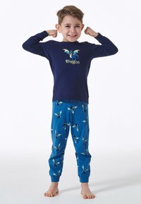 Marineblaues Langarmshirt mit Drachenmotiv und dem Text "Dragon". Blaue Schlafanzughose mit wiederholtem Drachenmuster. Weiches, figurnahes Material.