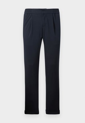 Pantalons bleu marine en tissu doux, dotés d'une taille élastique, de plis à l'avant et de bas de jambe à ourlet. Texture lisse, design minimaliste.