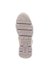Beżowa podeszwa sportowa z teksturowanym wzorem gripu. Charakteryzuje się wyraźnymi wypustkami i okrągłym logo blisko pięty. Wykonana z gumowego materiału, trwała konstrukcja.