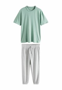 Mintgrünes T-Shirt mit kurzen Ärmeln aus Baumwolle, kombiniert mit hellgrauen, strukturierten Jogginghosen mit elastischem Bund und Kordelzug.