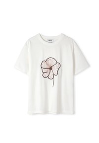 T-shirt blanc à manches courtes avec un col rond et un grand motif floral transparent brun unique au centre devant.