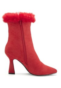 Red ankle boot made of soft suede with a pointed toe, featuring a fur-trimmed upper and a side zipper. The heel is approximately 3 inches.