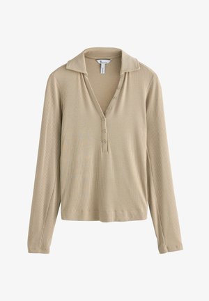 Beige long-sleeve polo with a ribbed texture, buttoned placket, and collar. Soft fabric with a relaxed fit and straight hem.