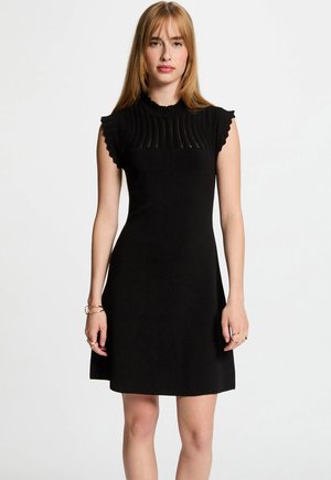 Black dress with a fitted bodice, pleated texture at the neckline, and ruffled short sleeves. Soft material with a flared skirt.