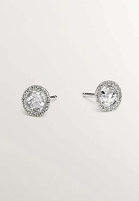 Pendientes de plata con cristales transparentes redondos en el centro, rodeados por un halo de pequeños strass brillantes, con un acabado pulido.