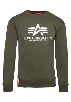 Olive green sweatshirt with a crew neckline and long sleeves. Features a white "Alpha Industries" logo and red accent tag at the hem.