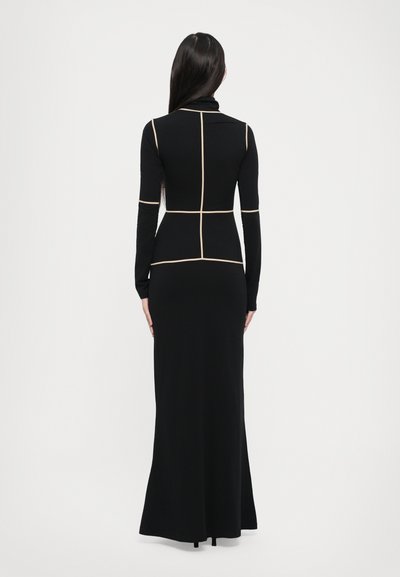 Black long-sleeve dress with a fitted silhouette, featuring contrasting beige lines creating a grid pattern and a floor-length hem.