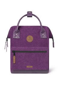 Purple corduroy backpack with leather accents, top handle, front zip pocket, and a circular logo patch on the front.
