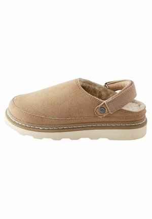 Light brown suede clogs with soft inner lining, back strap, white stitching, and a textured outsole for grip and comfort.