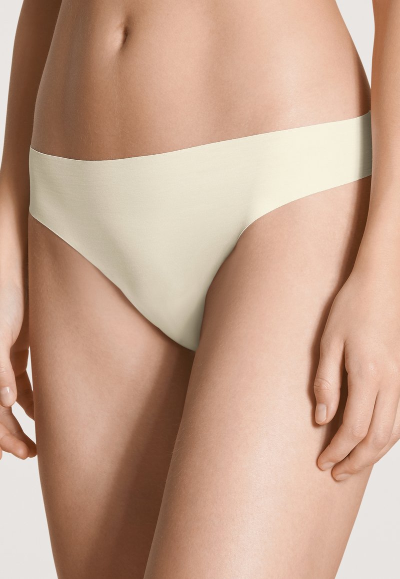 Beige katoenen bikini slipjes met een gladde textuur en een minimalistisch ontwerp. Beschikt over een lage tailleband en klassieke beenopeningen.