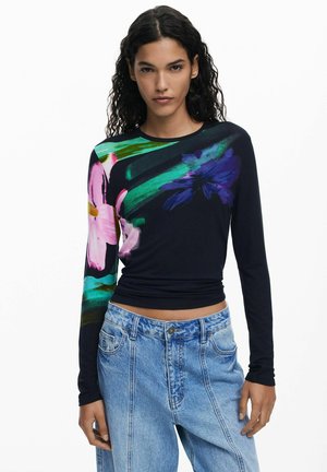 Long-sleeve black top featuring vibrant floral patterns in pink, purple, and teal. Soft fabric with a fitted design and round neckline.