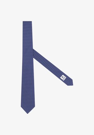 Blauwe zijden stropdas met een wit patroon van ineengestrengelde cirkels en een wit label met de tekst "B BOGGI Milano" aan het binnenste uiteinde.