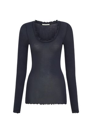 Mornarski dugi rukav s izrezom u obliku suze i volanima. Izrađen od laganog, prozračnog materijala s pripijenim siluetom.