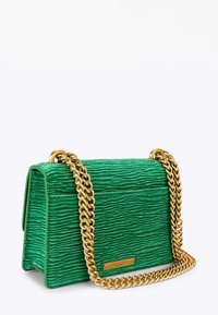Zielona torebka o fakturowanej powierzchni i prostokątnym kształcie, wyposażona w złoty łańcuszkowy pasek oraz metalową tabliczkę z logo z przodu.