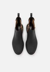 Black rubber ankle boots with a smooth finish, a pull tab at the back, and leopard print lining visible at the opening.