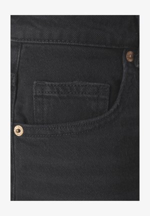 Black denim fabric with a front pocket, copper rivet detailing, and a textured finish. Features contrast stitching along edges.