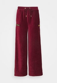 Pantalons de survêtement taille large bordeaux en tissu doux et pelucheux. Présentent une taille élastique avec cordon de serrage et des accents de logo brodés.