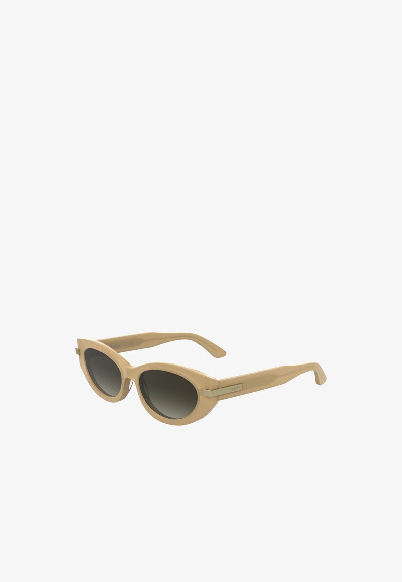 Sunglasses with a pale beige plastic frame, rounded cat-eye shape, dark gradient lenses, and gold-tone accents on the temple.