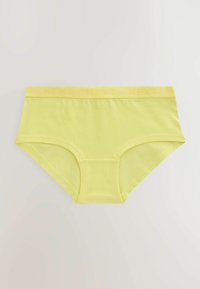 Slip di cotone giallo con una texture liscia e un elastico a contrasto che presenta il nome del marchio "NEXT" impressa.