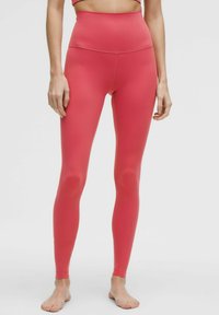 Hoge taille, aansluitende leggings in een levendig roze, gemaakt van een gladde, rekbare stof zonder zichtbare patronen of accenten.