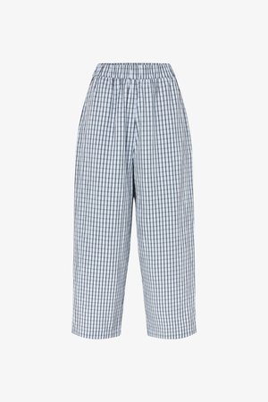 Pantalones de pierna ancha con cintura elástica, confeccionados en una tela ligera con un patrón de cuadros en blanco y negro.