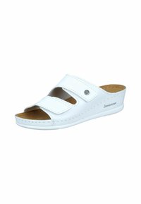 White slide sandal with two adjustable Velcro straps, cork insole, and a rounded toe. Features a textured upper and a slight heel.