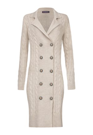 Beige cable-knit cardigan with a double-breasted design, notched collar, two side pockets, and six logoed buttons. Soft texture.