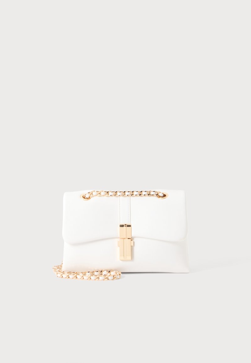 Sac à main rectangulaire blanc avec une fermeture dorée et une bandoulière chaîne dorée sur fond clair.
