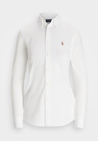 Chemise blanche à manches longues avec boutons, col boutonné et petit logo brodé d'un joueur de polo sur la poitrine.