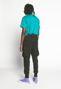 Urban Classics TACTICAL PANTS - Reisitaskuhousut - black