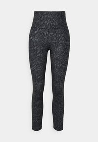 Höga svarta leggings med ett texturerat mönster som liknar djurmönster, tillverkade av elastiskt material för komfort och rörelsefrihet.