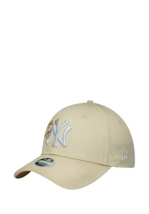 Khaki baseball cap with a curved brim. Features embroidered NY logo in white, gold accents, and eyelets for breathability.